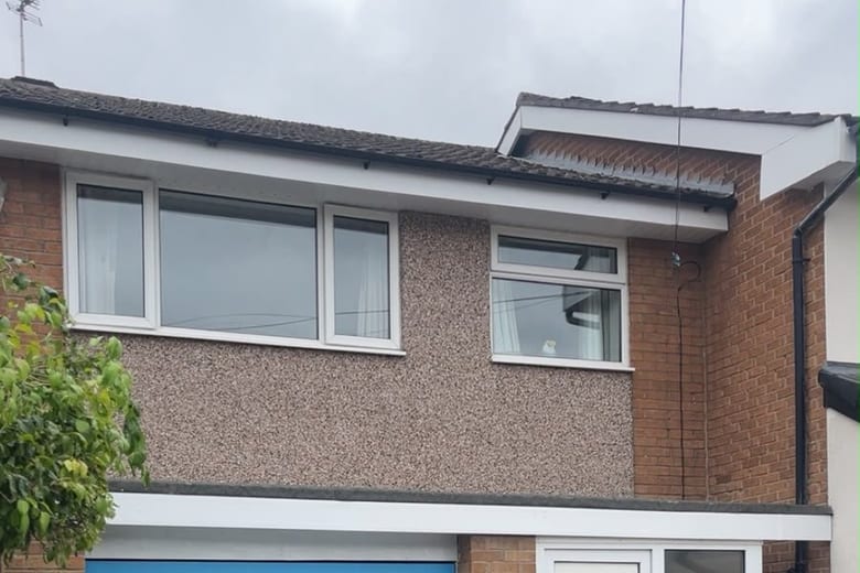 New white UPVC fascias, soffits and black guttering fitted to a semi-detached house in Stockport